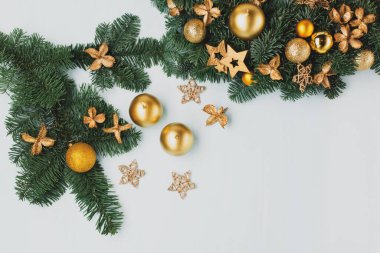 Mavi masadaki Noel çelengi, üst manzara. Altın mumlu modern noel çelengi, yeşil dallar ve mavi arka planda altın yıldızlar. Kış tatili zamanı.