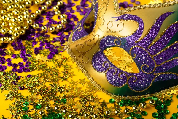 狂欢节的狂欢节面具 金黄色的珠子和黄色背景的金色 紫色的领带 宴会请柬 过冬狂欢节的概念 — 图库照片