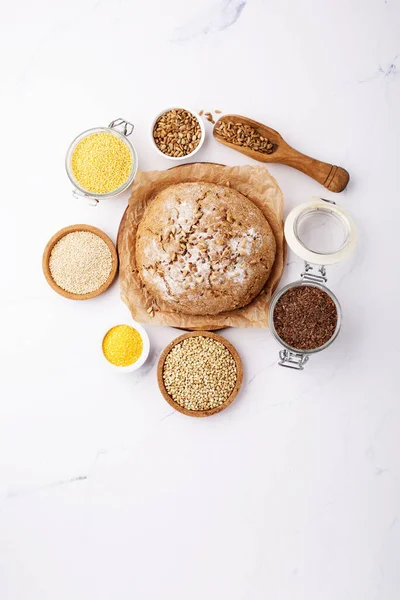 Ancient grain food. Bread Gluten free, Healthy eating, dieting, balanced food concept. Cereals gluten-free, millet, quinoa, polenta, buckwheat, flax seeds, sunflower seeds on white background.