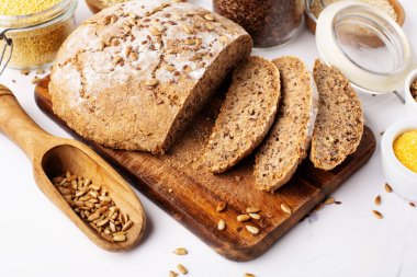 Ancient grain food. Bread Gluten free, Healthy eating, dieting, balanced food concept. Cereals gluten-free, millet, quinoa, polenta, buckwheat, flax seeds, sunflower seeds on white background.