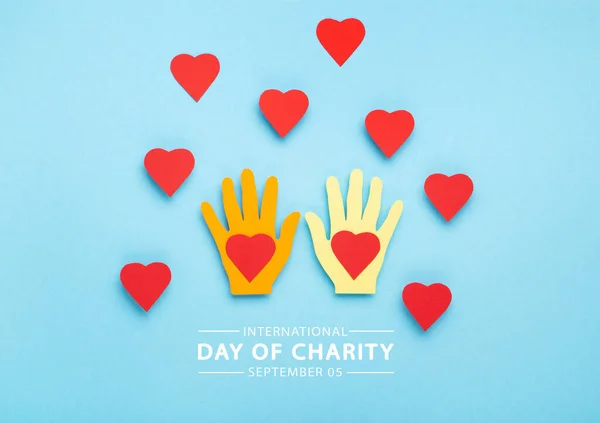 International Day of Charity, 5 September. Tolerance, kindness, cooperative, friendship, charity, humanitarian aid day concept. Colorful hands on blue background, copy space, top view.