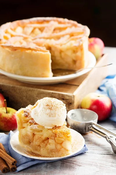 Homemade Apple Pie with apples and ice cream on White rustic wooden background. Festive pastry for Thanksgiving day, Autumn Holiday, Fall. Cozy holiday concept.