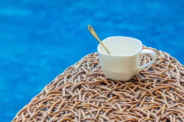 Coffee cup on rattan wicker — Stock Photo, Image