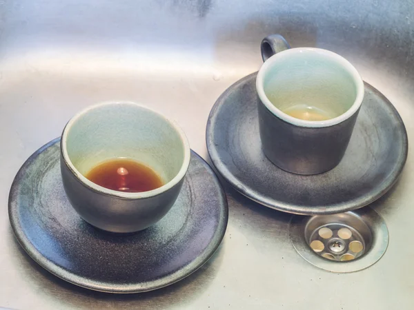 Coffee cup in sink — Stock Photo, Image