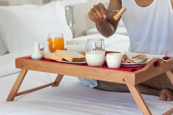Breakfast on tray in bed — Stock Photo, Image