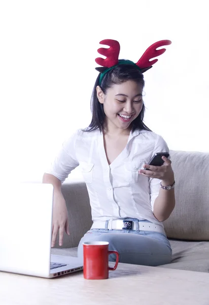 Happy Asian girl with phone and computer indoor — Stock Photo, Image
