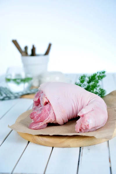 Meat, fresh, pink pork leg with fat on cut board