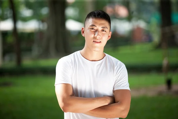 Portrait of young handsome asian in the park — Stock Photo, Image