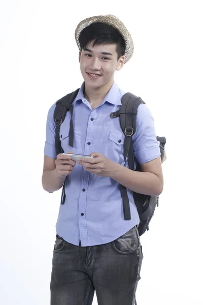 Portrait of a young Asian handsome student guy using internet on cellphone — Stock Photo, Image