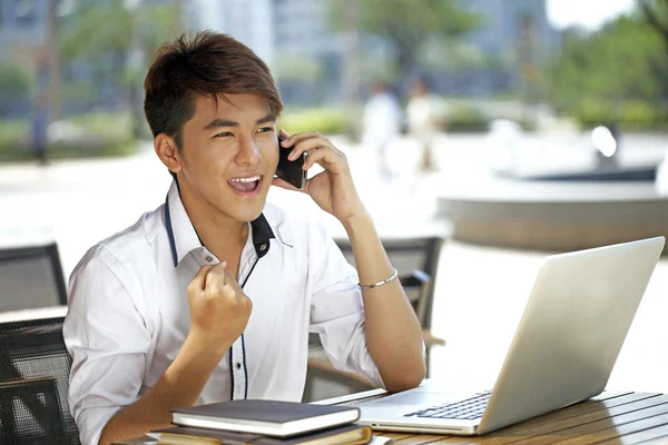 A asian student using laptop outdoor — Stock Photo, Image