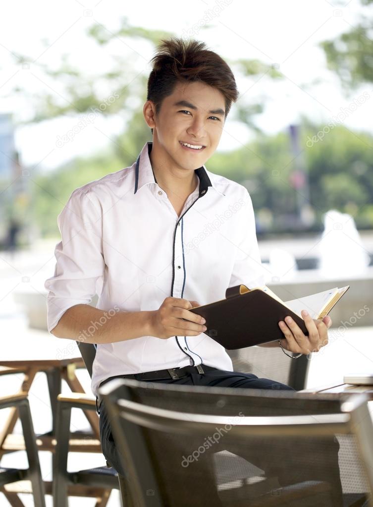 A asian student with book outdoor