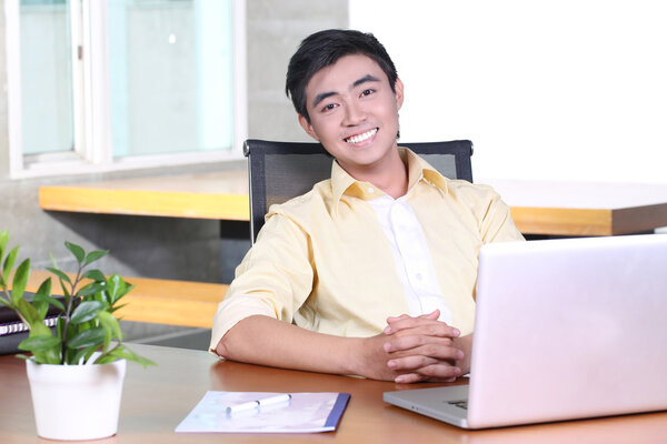 Relaxed young Asian businessman
