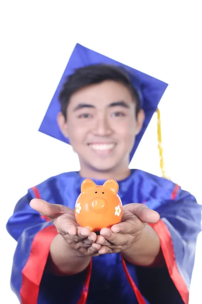 Young Asian graduation student guy with piggy bank - isolated on white — Stock Photo, Image