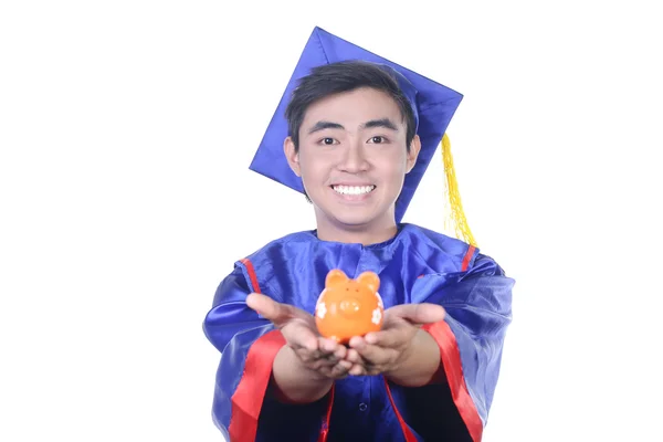 Young Asian graduation student guy with piggy bank - isolated on white — Stock Photo, Image