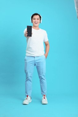 Asyalı yakışıklı ve neşeli genç adam, arka planda soyutlanmış.