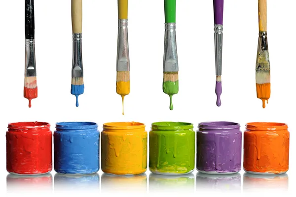 Paintbrushes Dripping into Paint Containers — Stock Photo, Image