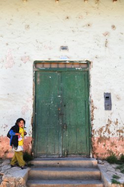 Young Girl Walking by Old Door clipart