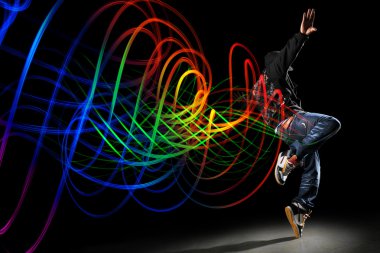 Dancer with Waves of Light Over Black Background clipart