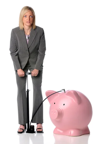 Businesswoman Blowing Up Piggy Bank — Stock Photo, Image