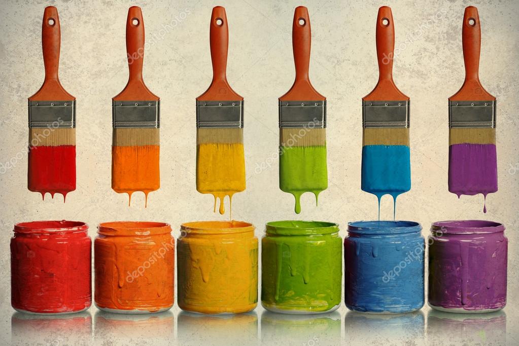 Paintbrushes Dripping into Paint Containers Stock Photo by