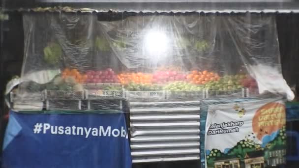 Obchod Ovocem Hustým Deštěm Popředí Rušnými Vozidly Projíždějícími Kolem Denpasar — Stock video