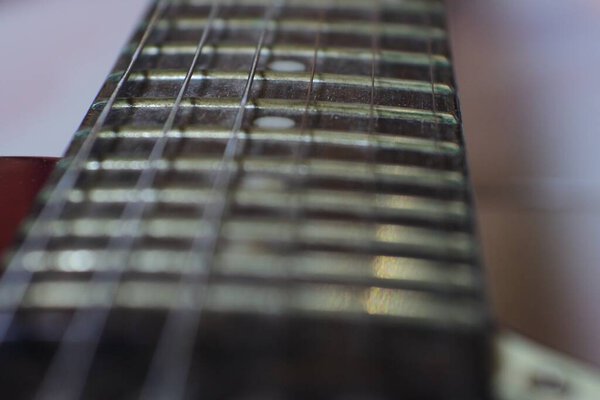 Electric guitar Fretboard closeup macro slider shot. Guitar pegs on a six-string guitar. musical instrument