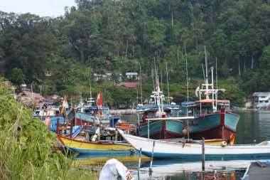 View of the river and boats and the activities of residents near the Siti Nurbaya Padang bridge, West Sumatra, Indonesia, Indonesia - May 21th 2022.