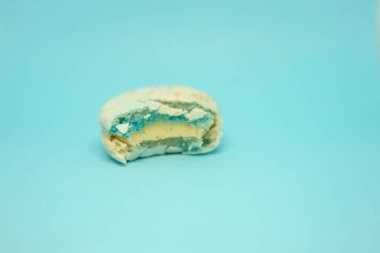 Mavi arka planda mavi bir badem kurabiyesi. Lezzetli taze tatlı. Tek renk olsun. Yılın rengi.