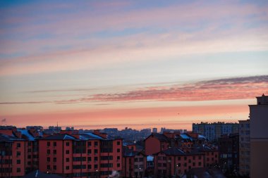 Şafak vakti şehir manzarası. Mavi duman bacadan çıkıyor. Evlerin üzerinde pembe gökyüzü. Yüksek kalite fotoğraf