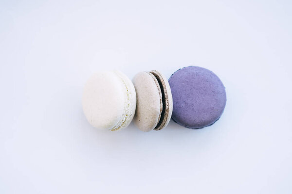 purple gray and white macarons on a white background fresh and delicious dessert. High quality photo