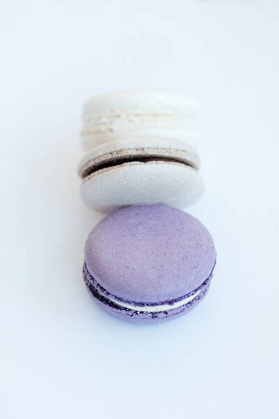 purple gray and white macarons on a white background fresh and delicious dessert. High quality photo