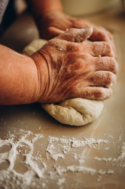 Making dough by male hands at bakery. Food concept. High quality photo