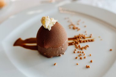 Lüks bir restoranda, tatlı olarak lezzetli bir çikolatalı dondurma sunulur..