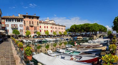 Desenzano del Garda, İtalya - 22 Eylül 2021: Desenzano 'da güneşli bir günde Garda Gölü' nün küçük eski limanını görmek.