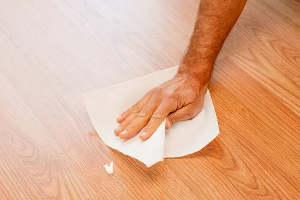 Man Hand Wiping White Cream Stain Wooden Floor Tissue — Stock Photo, Image