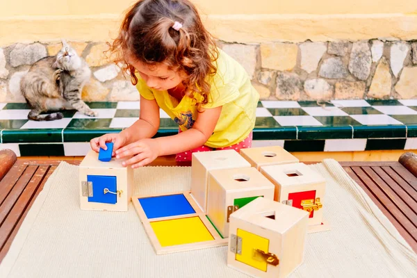 Girl Learns Using Her Hands Play Wooden Boxes Locks Montessori — Stock Fotó