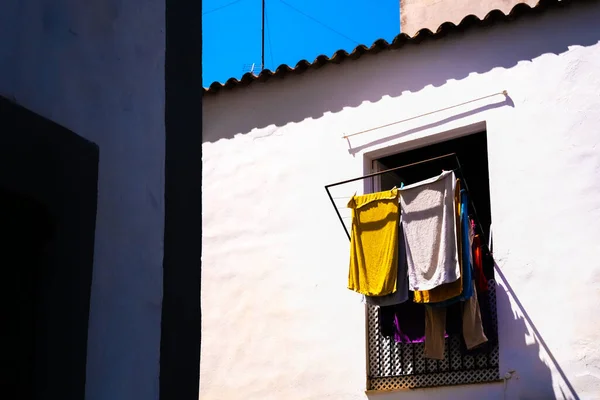 Clothes hung out in the sun to dry on a hot summer day in the Mediterranean, a sustainable way of living.