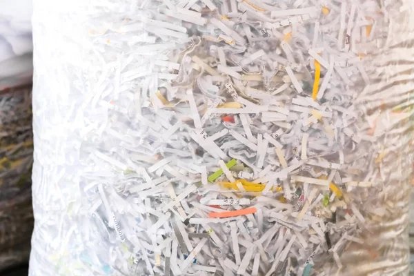 Shredded paper shreds in a bag, documents destroyed for privacy.