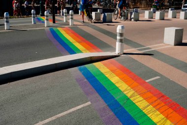 Geneva, Switzerland - August 25, 2022: Pedestrian crossings with the gay pride rainbow flag on the streets of a populous city.