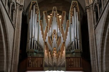 Pipe organ of Saint Peter's Cathedral in Geneva, Switzerland, surrounded by beautiful stone arches.