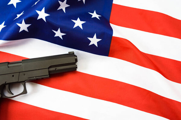 Americans are proud to bear arms, detail of a pistol on a flag.
