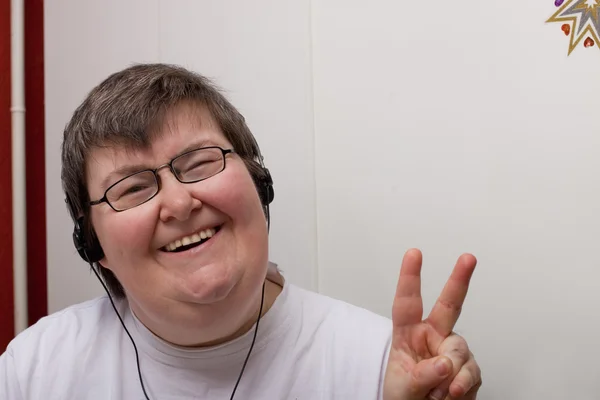 Mentally disabled woman with earphone —  Fotos de Stock
