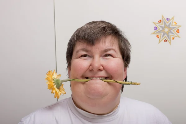 Mentally disabled woman with flower — Stok fotoğraf