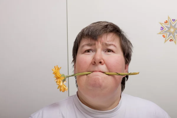 Mentally disabled woman with flower — 스톡 사진