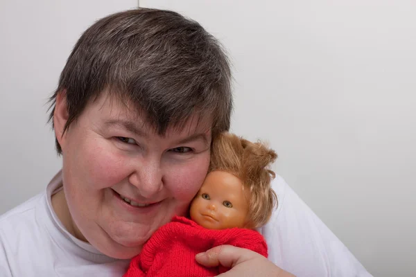 Mentally disabled woman with doll — 图库照片