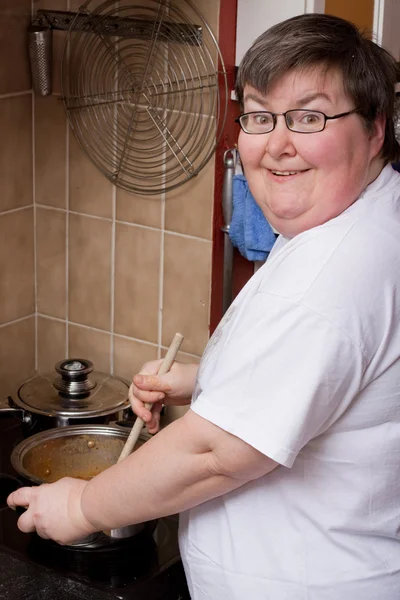 Mentally disabled woman is cooking — Foto Stock