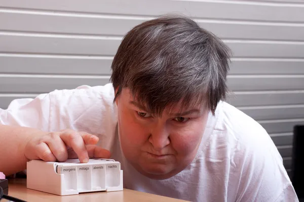 Mentaly disabled woman with pharmaceutical — Foto Stock