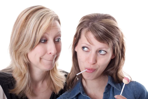 Blond woman wants lolly from brunette woman — Stock Photo, Image