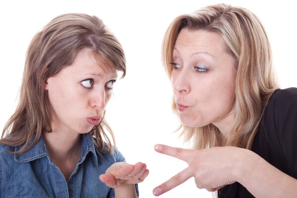 two young women are playing rock, paper, scissors