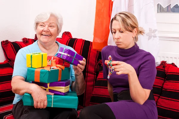 Female senior with a lot of gifts — Stok fotoğraf